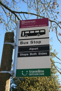 A sign reading 'bus stop - Alport - stops both sides'.