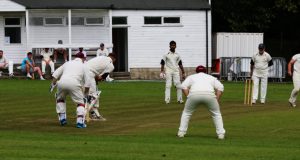 Cricketers playing in cricket whites.