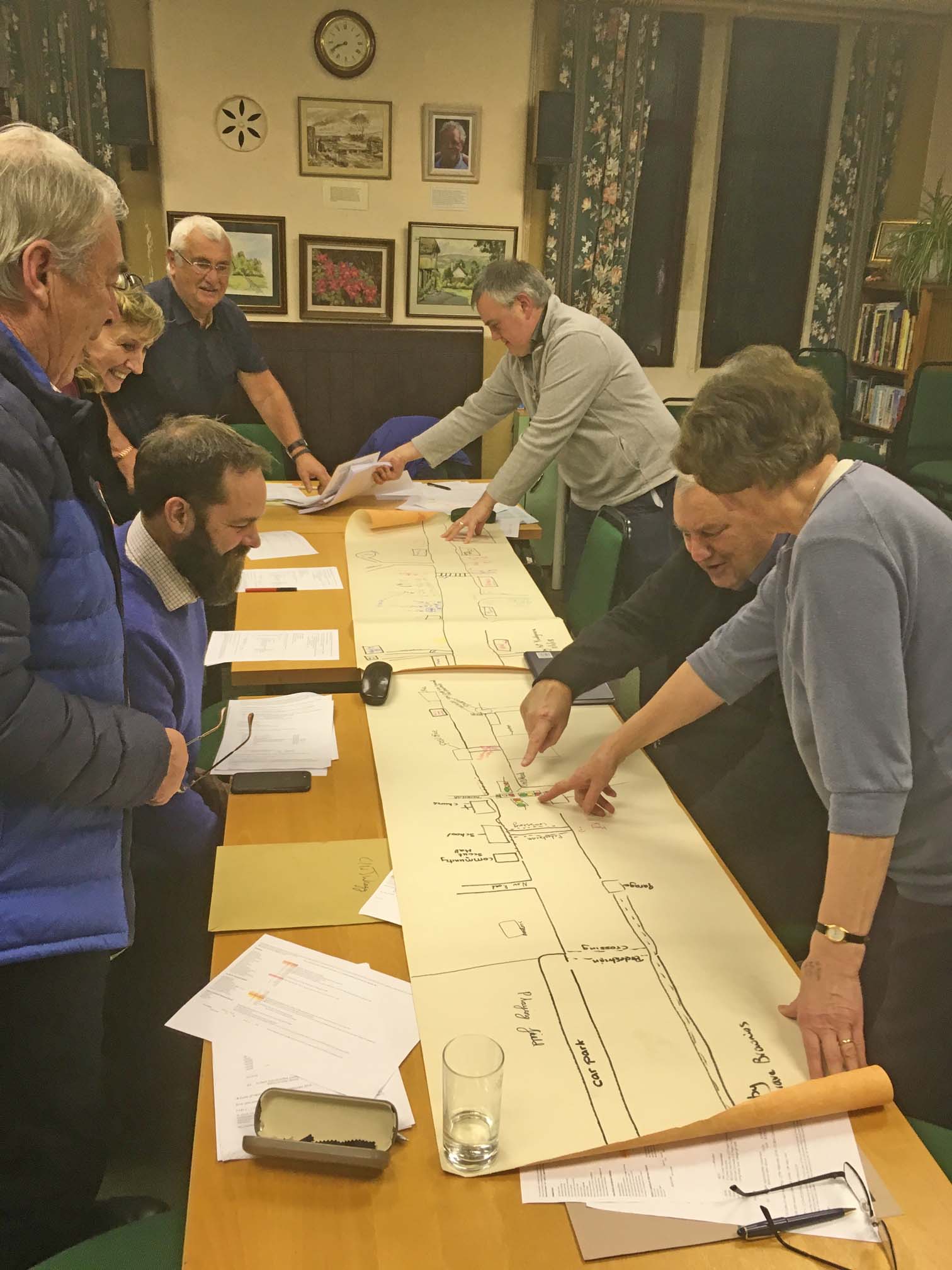 Councillors looking at a long, hand drawn map of Youlgrave.