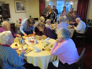 Residents sat around tables at a party.